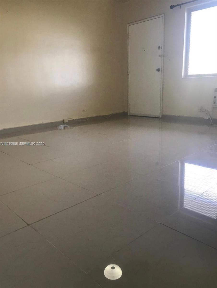 70 Northwest 77th Street, Unit 9 Miami, FL 33150 - Photo 12 of 13 an empty room with a window