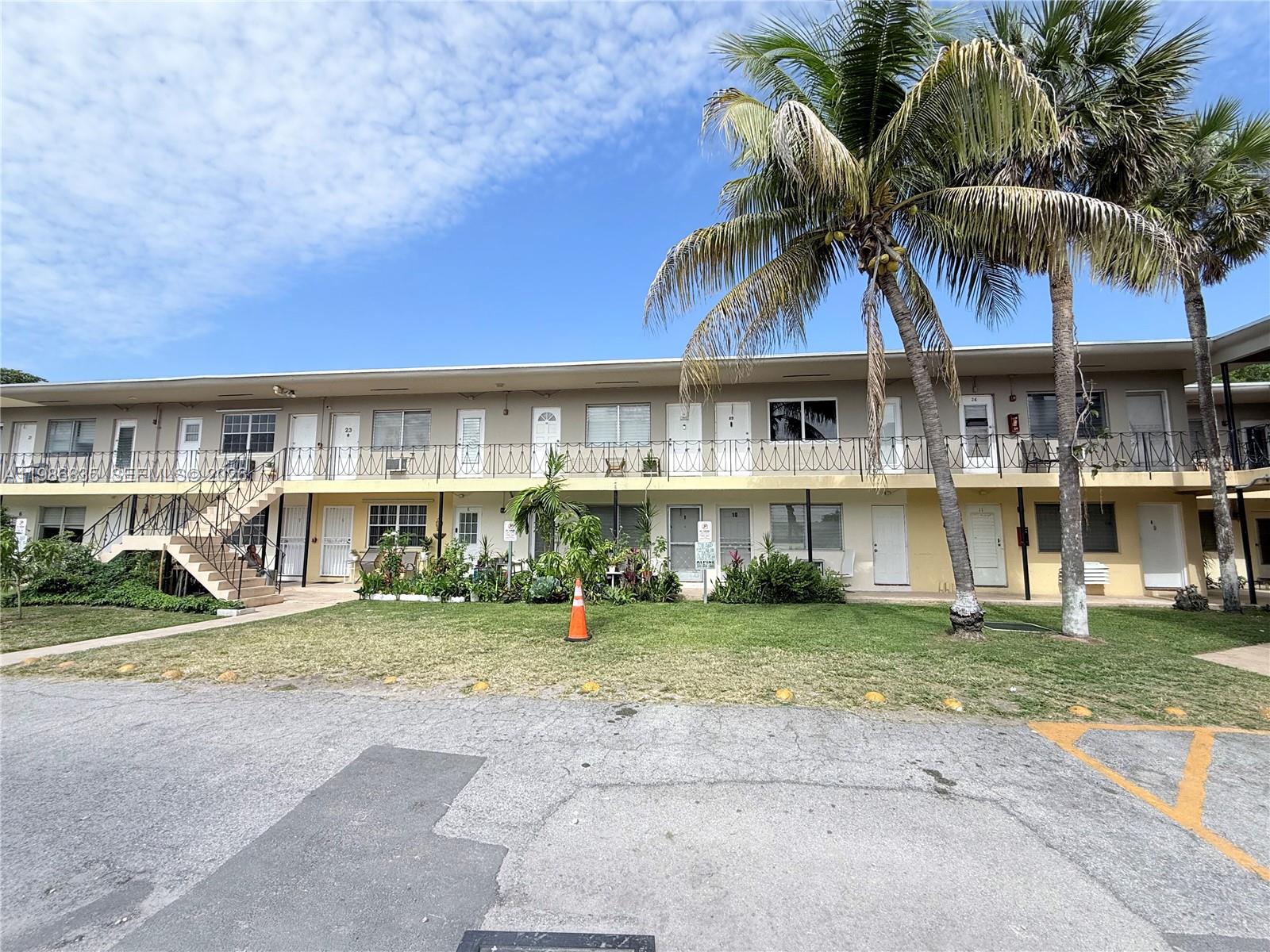 70 Northwest 77th Street, Unit 9 Miami, FL 33150 - Photo 2 of 13 front view of house with a yard and potted plants