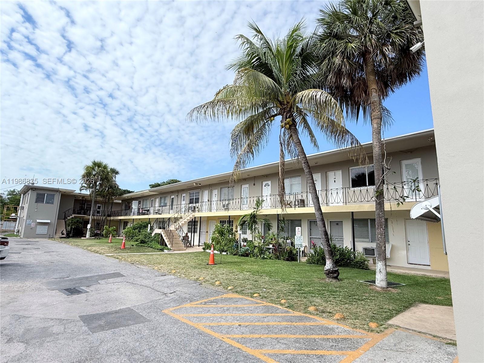 70 Northwest 77th Street, Unit 9 Miami, FL 33150 - Photo 3 of 13 a front view of a house with garden and a tree