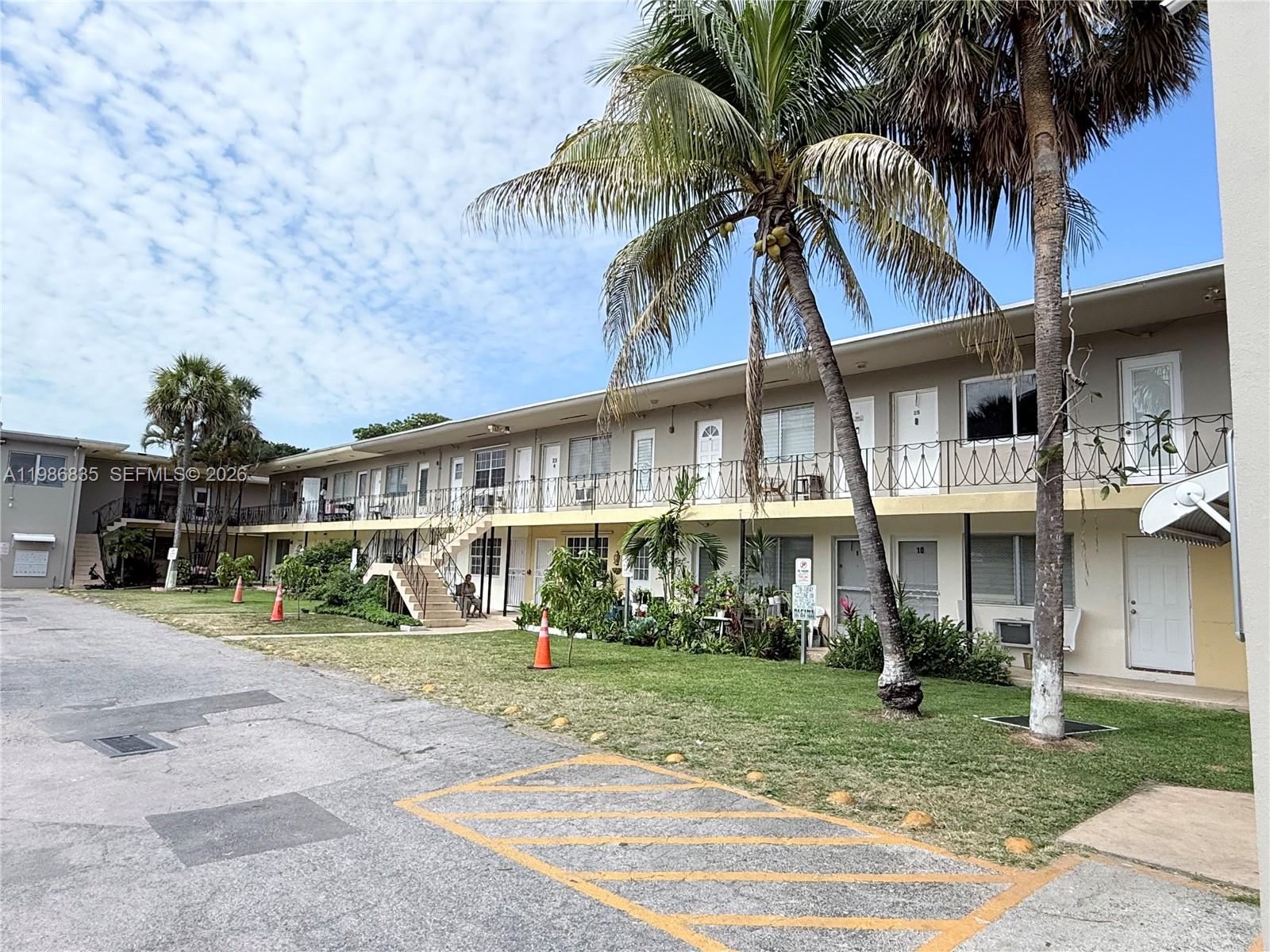 70 Northwest 77th Street, Unit 9 Miami, FL 33150 - Photo 4 of 13 a view of a house next to a yard with palm trees