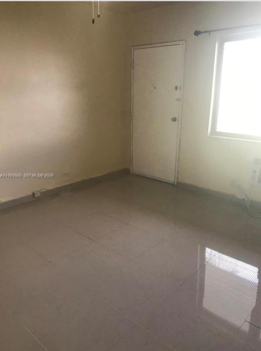 70 Northwest 77th Street, Unit 9 Miami, FL 33150 - Photo 6 of 13 an empty room with a window