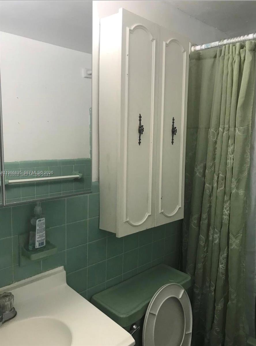 70 Northwest 77th Street, Unit 9 Miami, FL 33150 - Photo 9 of 13 a bathroom with a sink a toilet and shower