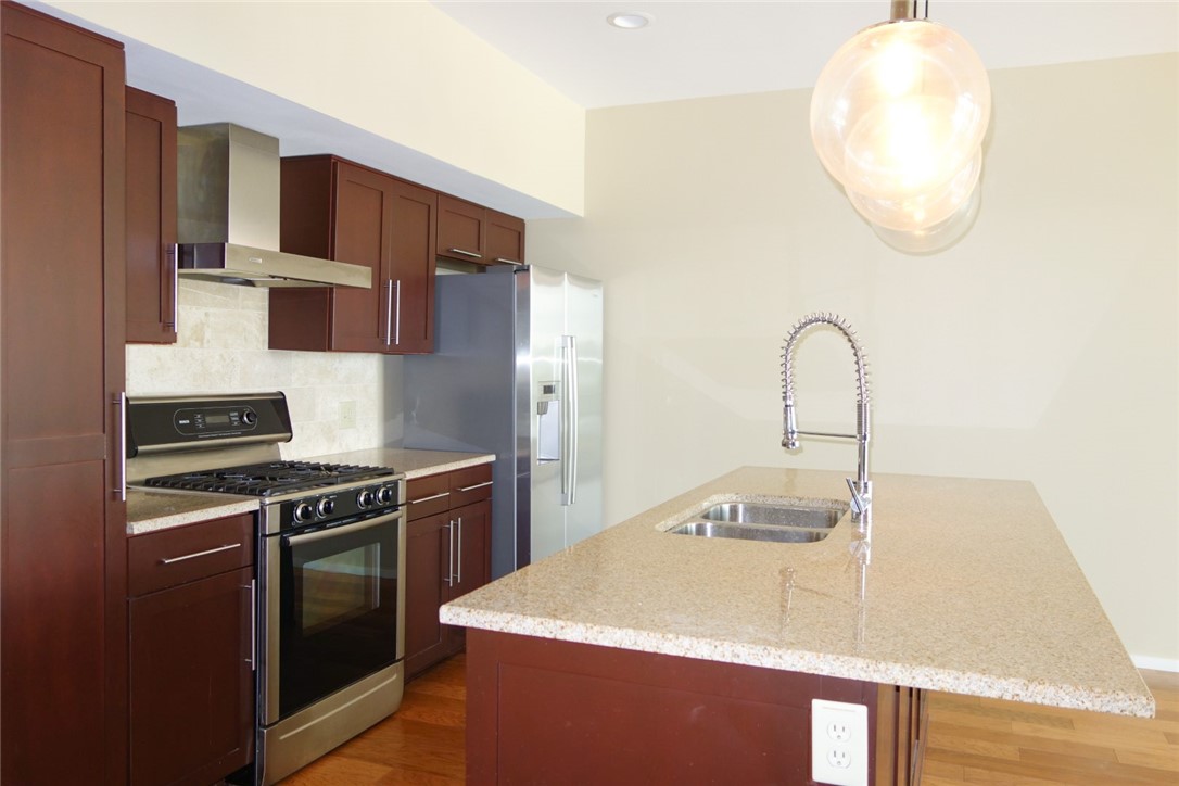1600 Barton Springs Road, Unit 1407 Austin, TX 78704 - Photo 13 of 38 a kitchen with stainless steel appliances granite countertop a sink and a stove