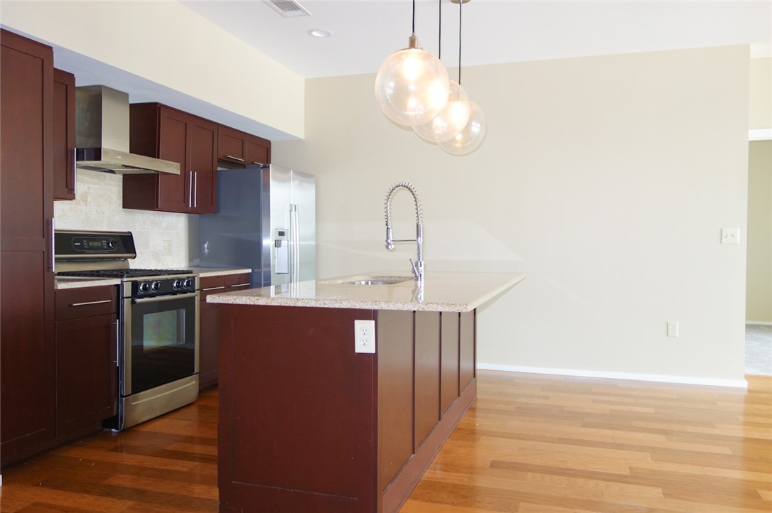 1600 Barton Springs Road, Unit 1407 Austin, TX 78704 - Photo 14 of 38 a kitchen with stainless steel appliances a stove a microwave and a refrigerator