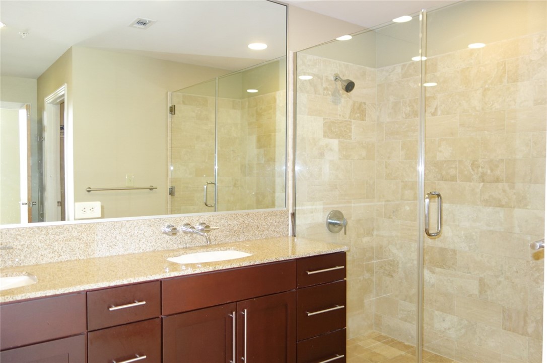 1600 Barton Springs Road, Unit 1407 Austin, TX 78704 - Photo 19 of 38 a bathroom with a sink shower and a mirror