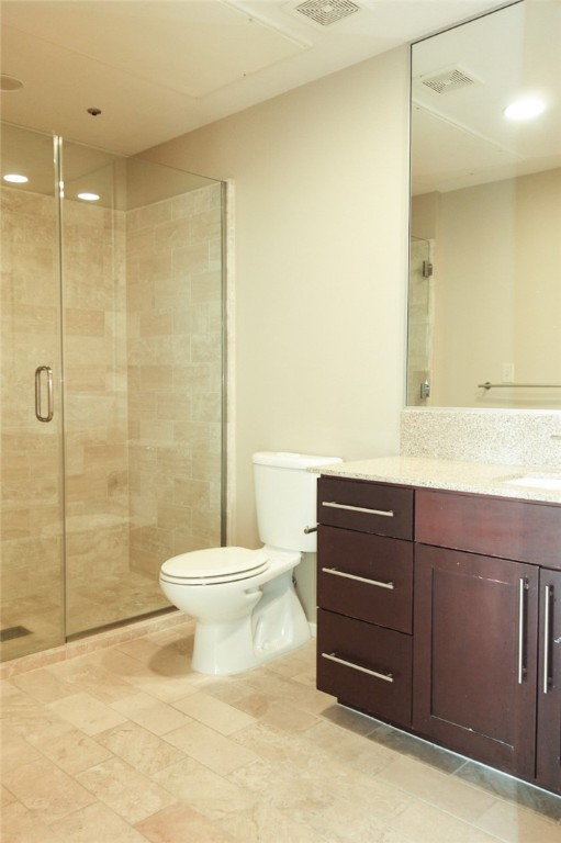1600 Barton Springs Road, Unit 1407 Austin, TX 78704 - Photo 27 of 38 a bathroom with a sink a toilet and shower