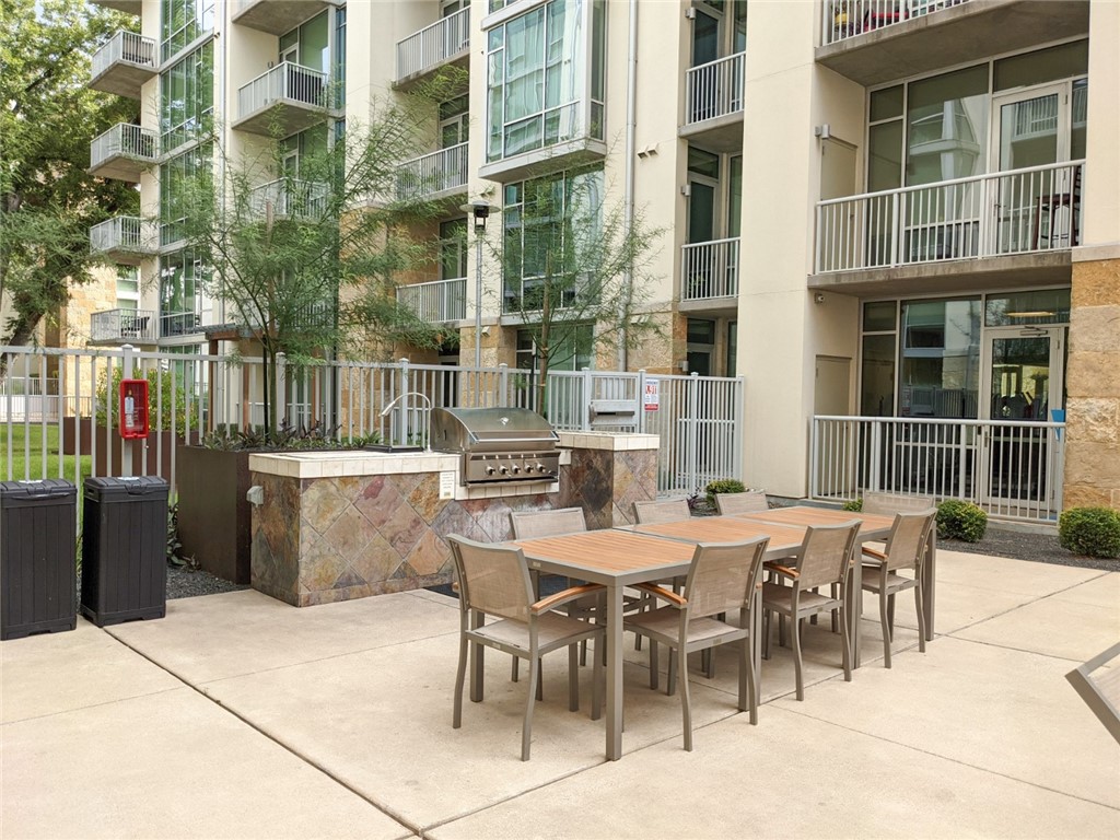 1600 Barton Springs Road, Unit 1407 Austin, TX 78704 - Photo 30 of 38 a view of a dinning table and chairs in the patio