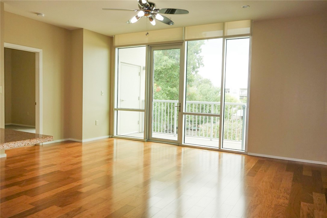 1600 Barton Springs Road, Unit 1407 Austin, TX 78704 - Photo 3 of 38 a view of an empty room with wooden floor and a window