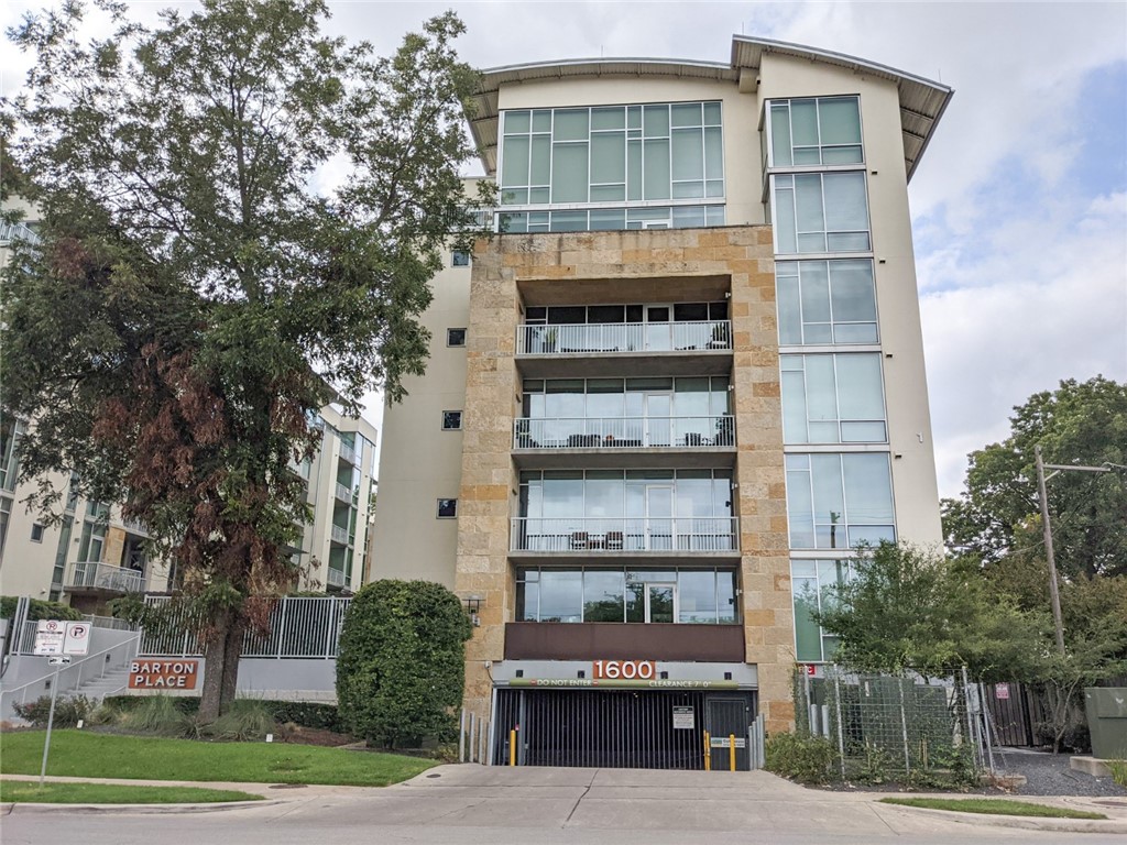 1600 Barton Springs Road, Unit 1407 Austin, TX 78704 - Photo 37 of 38 a view of a large building with a large windows and a tree