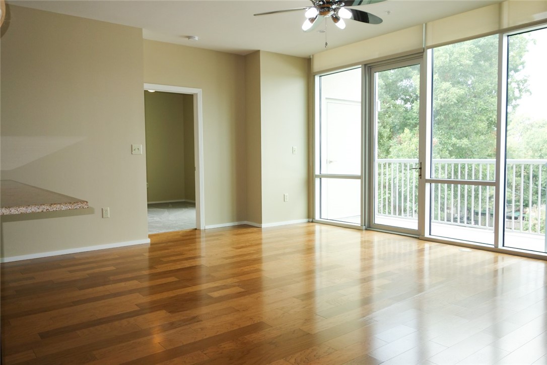 1600 Barton Springs Road, Unit 1407 Austin, TX 78704 - Photo 4 of 38 a view of an empty room with window a ceiling fan and wooden floor