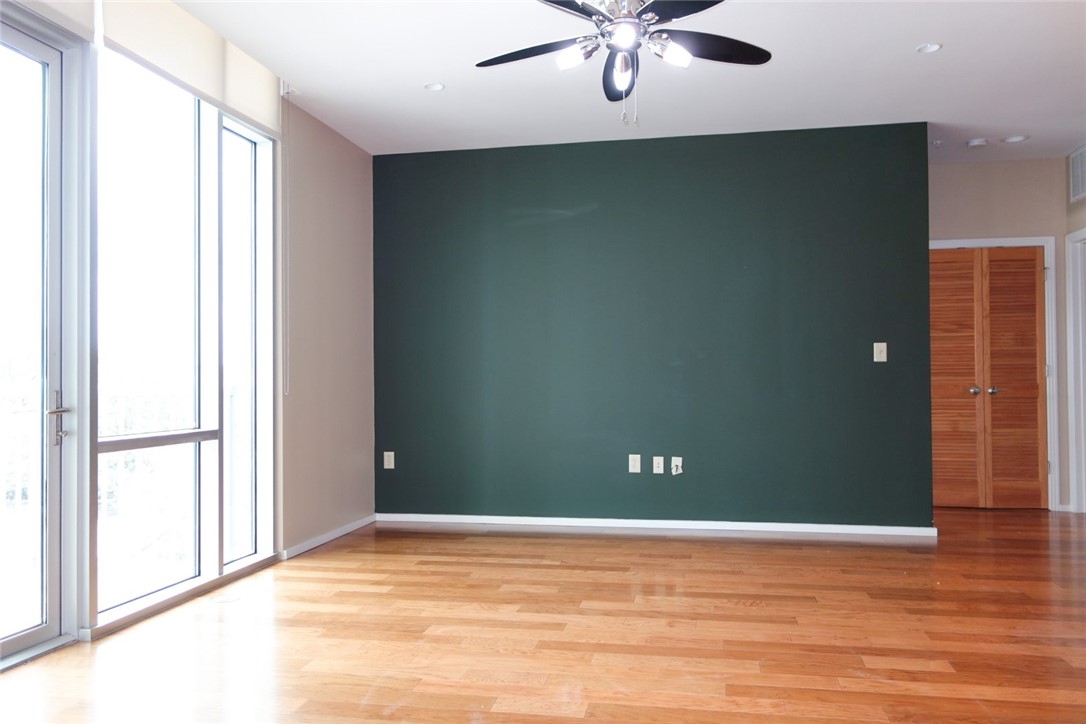 1600 Barton Springs Road, Unit 1407 Austin, TX 78704 - Photo 10 of 38 an empty room with wooden floor and windows