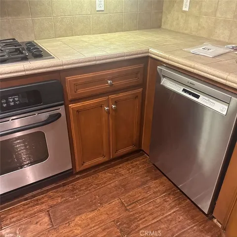 a view of a kitchen with wooden floor