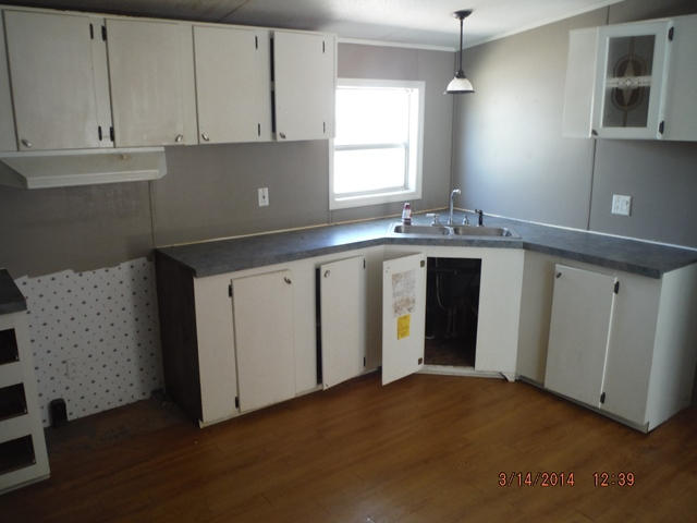 2310 James Peaden Road Baker, FL 32531 - Photo 6 of 7 a kitchen with a sink and cabinets