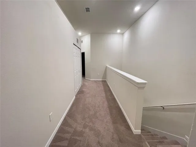 a view of a hallway with stairs