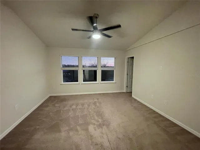 a view of an empty room with a kitchen
