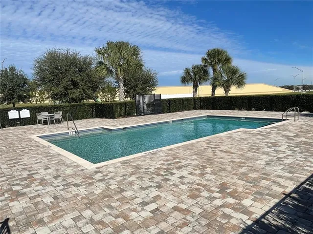 a view of a swimming pool with a patio