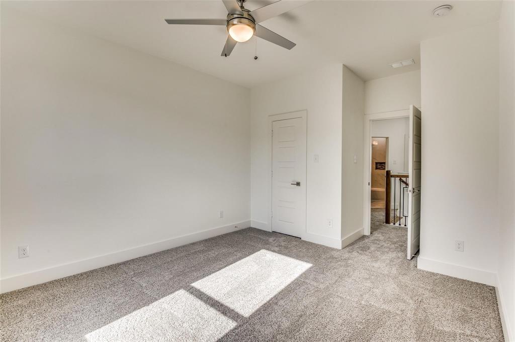7307 Rubio Place Dallas, TX 75235 - Photo 13 of 17 an empty room with a ceiling fan and a window