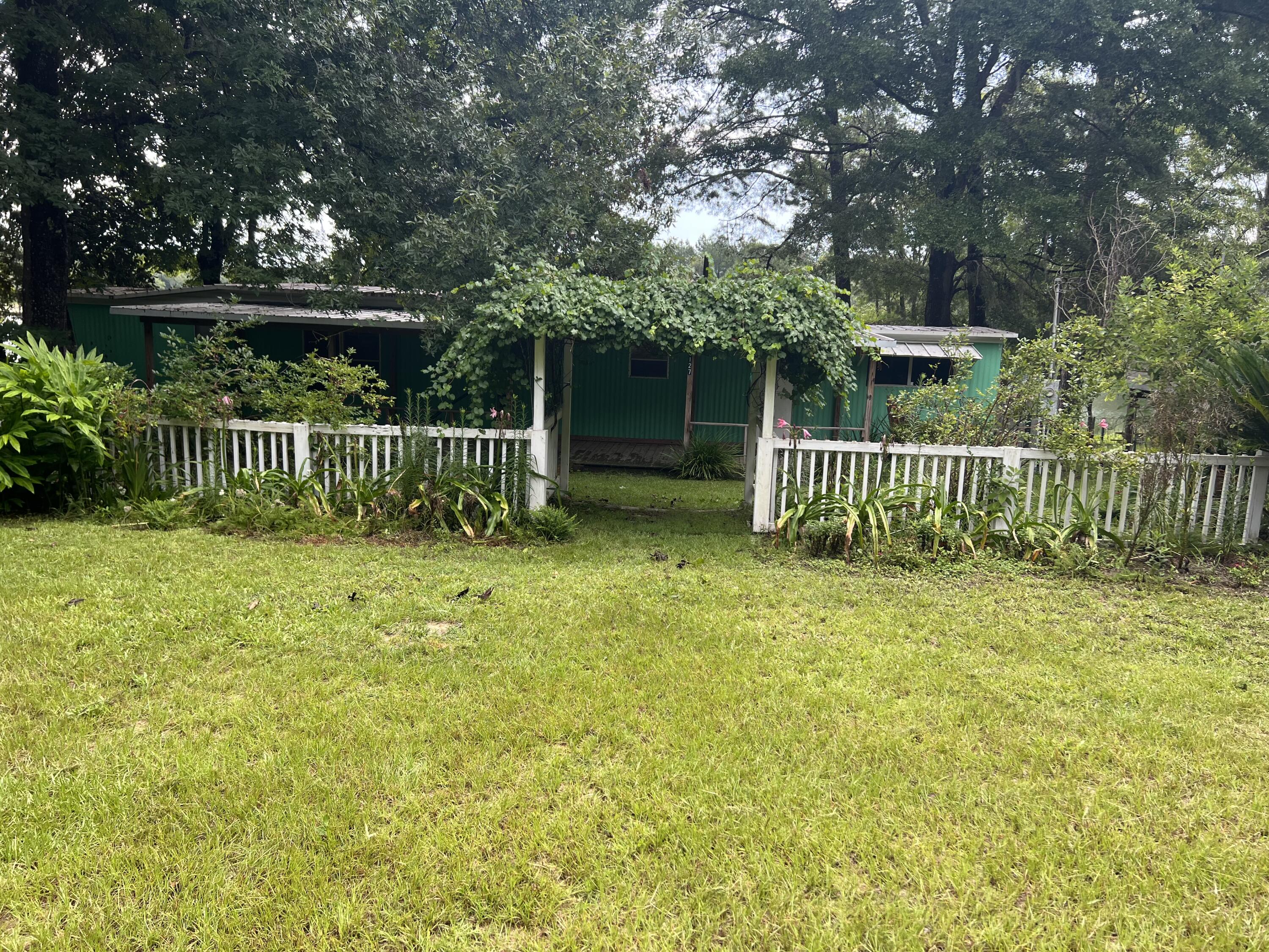5127 Redbug Lane Vernon, FL 32462 - Photo 4 of 18 a view of garden with deck and a garden