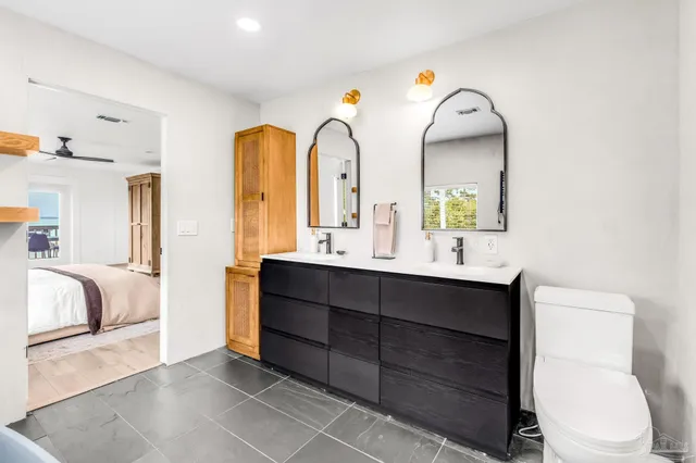 a bathroom with a double vanity sink and a toilet