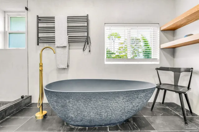 a living room with a table and a chair