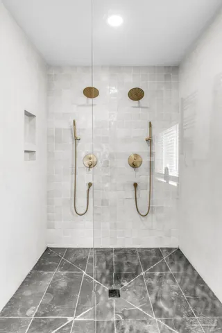 a bathroom with a granite countertop shower