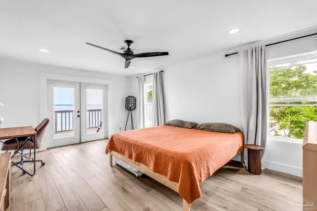 a bedroom with a large bed and a window