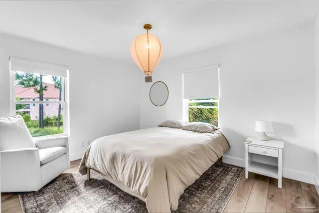 a bedroom with a bed and a chandelier