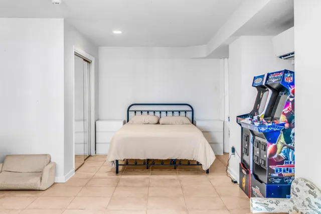 a bedroom with a bed and a large window