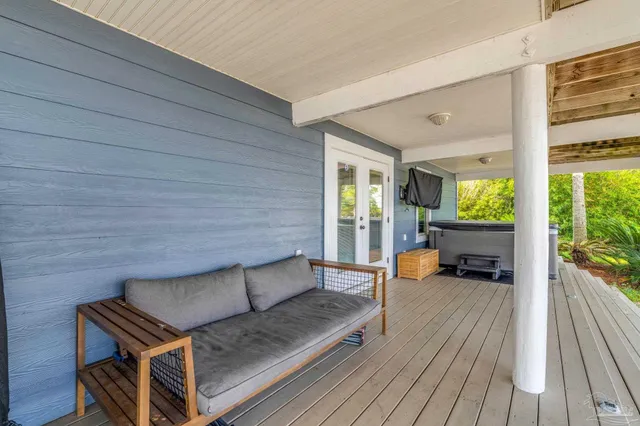 a view of a house with swimming pool and porch with furniture
