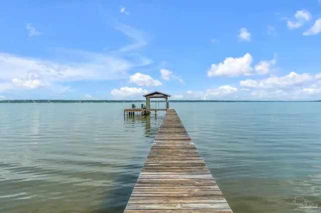 a view of a balcony with wooden floor and outdoor space