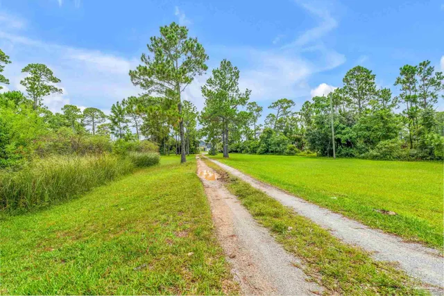 an aerial view of a house with swimming pool and mountain view