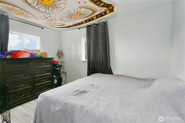 a bed room with a bed and a mirror