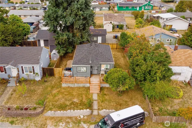 an aerial view of residential houses with yard