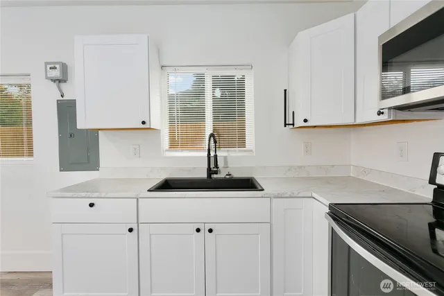 a kitchen with a sink and cabinets
