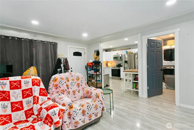 a bedroom with furniture and a wooden floor