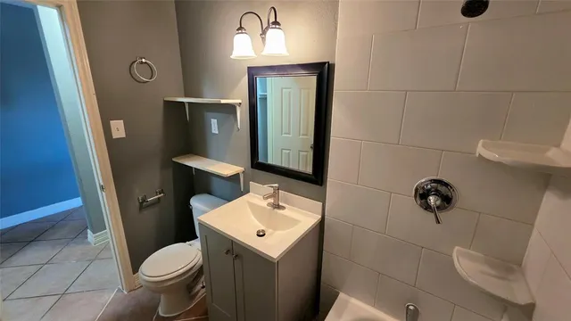 a bathroom with a toilet a sink and shower
