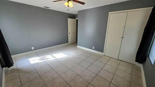 a view of a house with a wooden fence