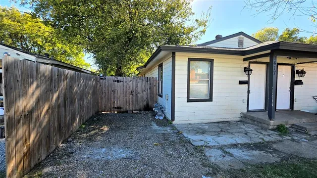a pathway of a house with a tree