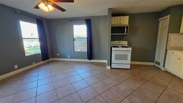 a kitchen with a sink a stove and cabinets