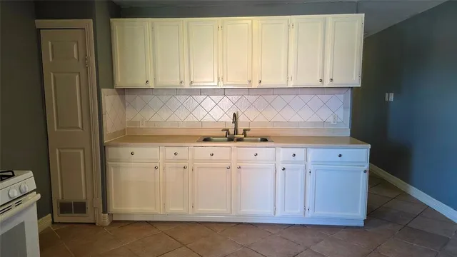 a view of a hallway with wooden floor and glass door