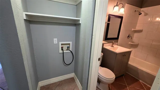 a bathroom with a sink a toilet a mirror and shower