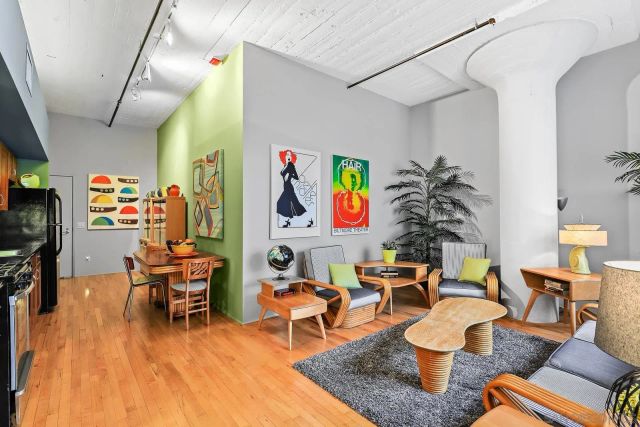a living room with furniture and wooden floor