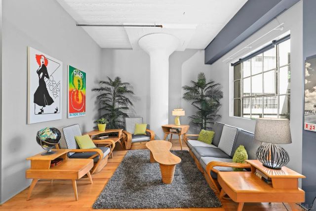 a living room with furniture and a potted plant