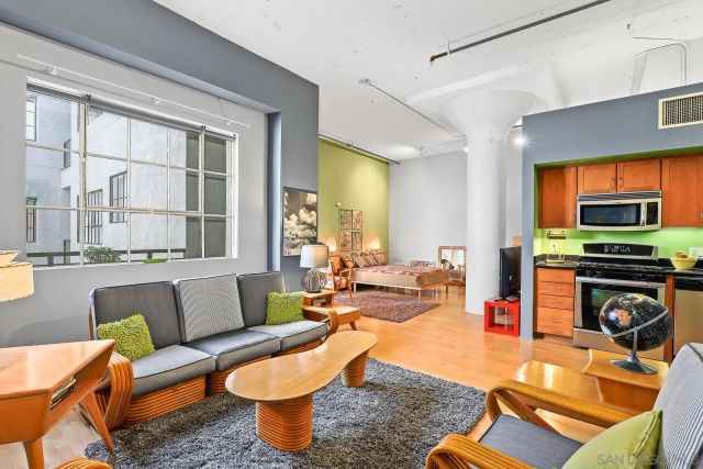 a living room with furniture a flat screen tv and a fireplace