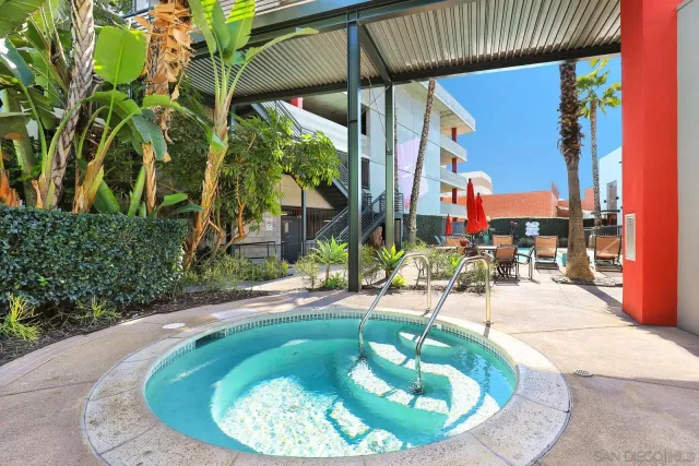 a view of a swimming pool with sitting area