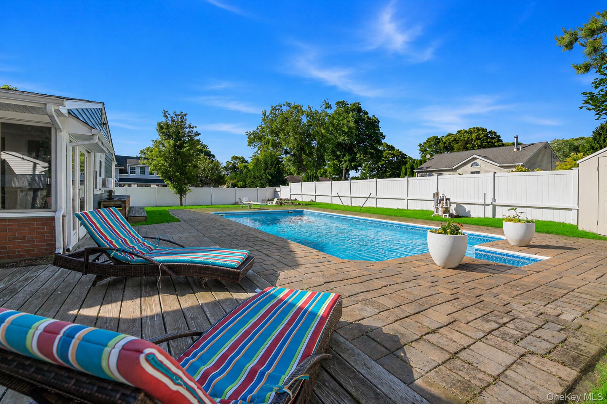33 Lillian Road Nesconset, NY 11767 - Photo 28 of 42 The Spectacular Entertainer's Backyard Offers A Saltwater In Ground Pool With A Diving Board, Expansive Paver Patios & Paver Pool Surround, And The Pool Is Always Warm Because Of Constant Direct Sunlight.