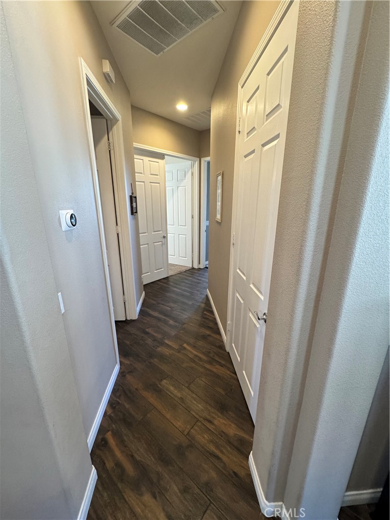 11000 Rockaway Glen Road Apple Valley, CA 92308 - Photo 6 of 17 a view of a hallway with wooden floor and staircase