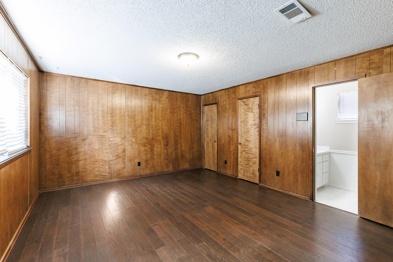 3603 77th Drive Lubbock, TX 79423 - Photo 50 of 72 a view of an empty room with wooden floor and a window