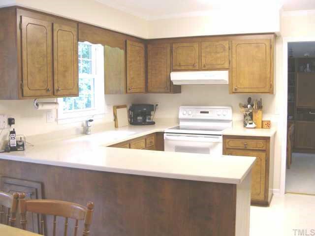 1200 Coldstream Court Raleigh, NC 27615 - Photo 6 of 12 a kitchen with a window a sink and a refrigerator