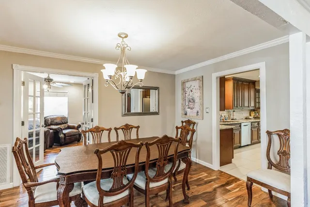 a view of a dining room with furniture and chandelier